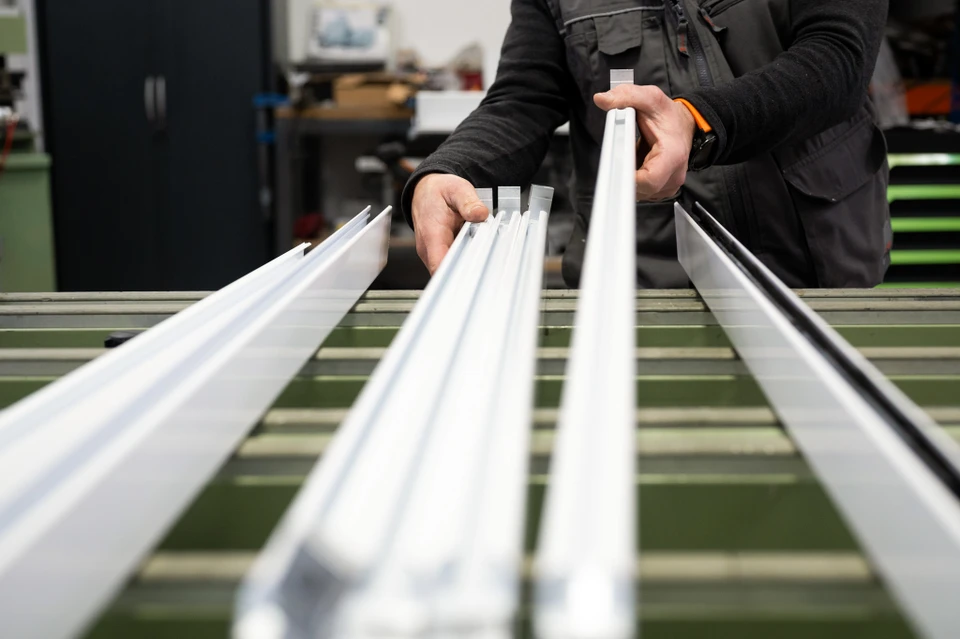 Artisan menuisier consulte une tablette numérique dans son atelier